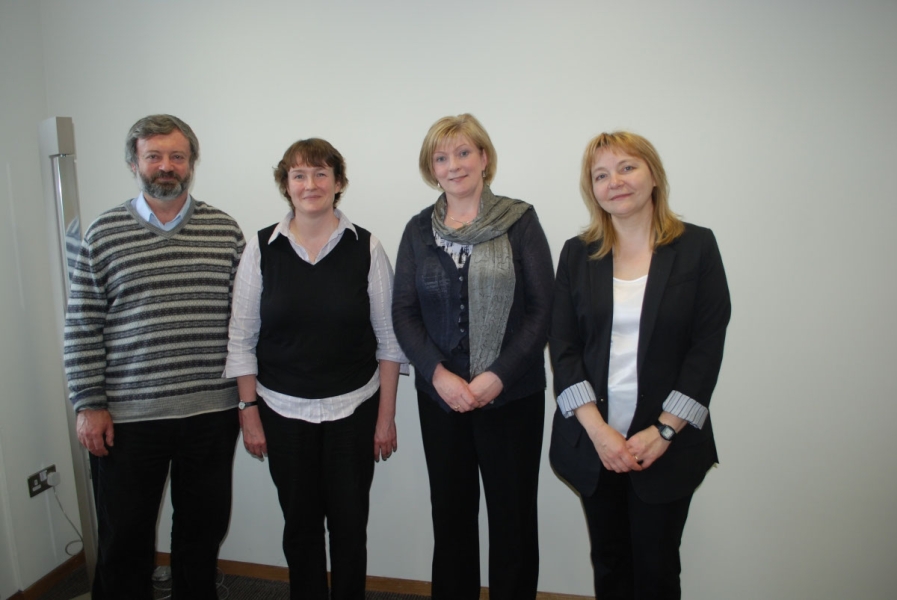 four people pose for a picture