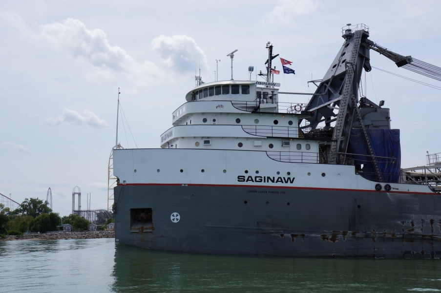 The front of a very large boat, with a three story pilot house. There is a crane behind the pilot house.