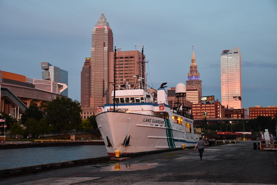 A ship Lake Guardian docked in a city