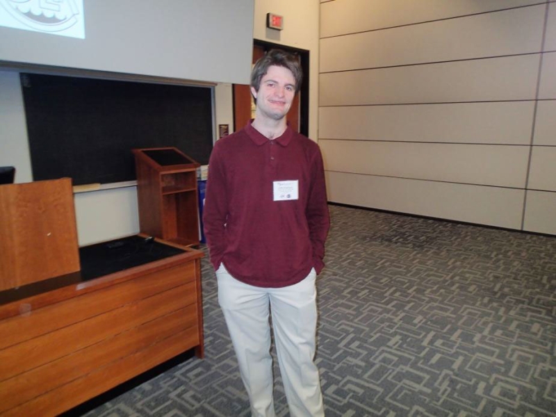 a person standing near the front of a lecture hall